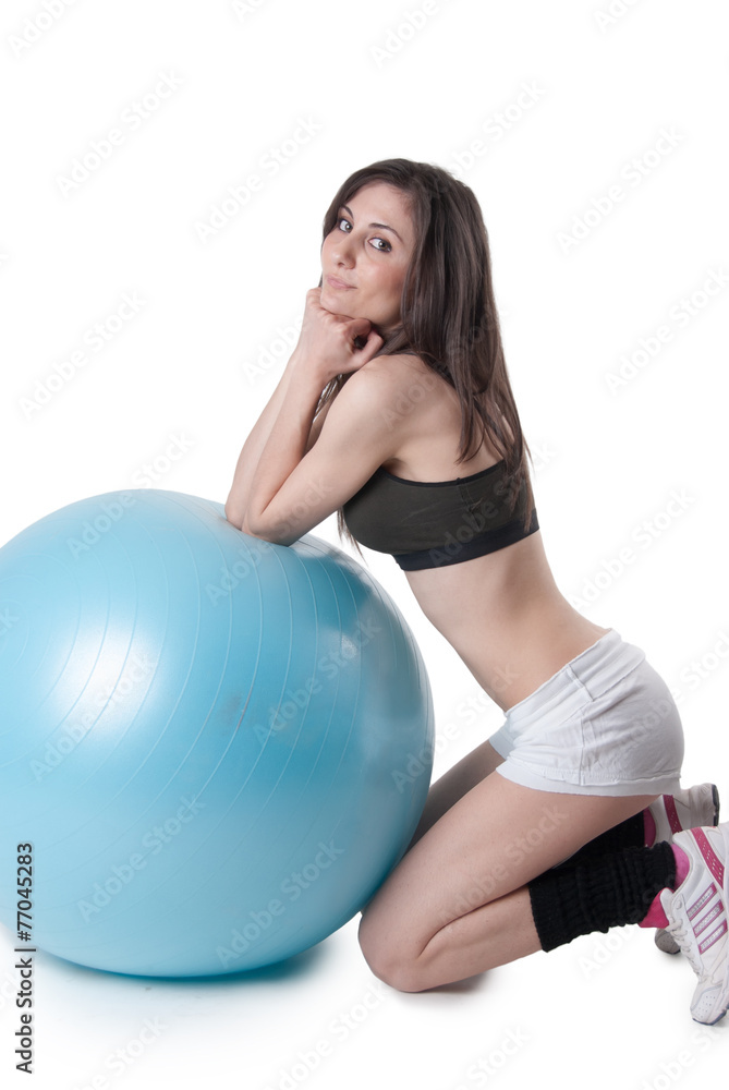 Young athletic woman with blue exercise ball Young athletic woman with blue exercise ball