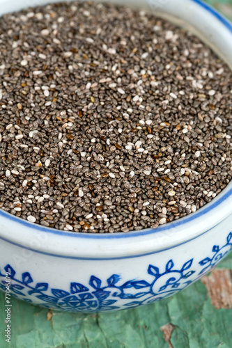 chia seeds in a bowl on wooden surface