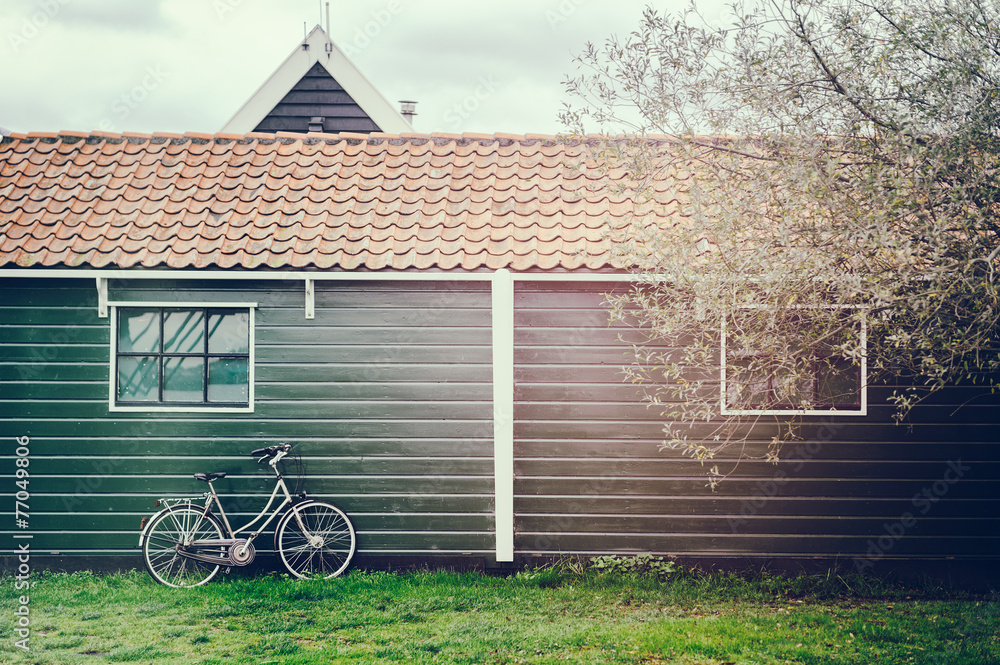 Old bicycle leaning against wooden barn Old bicycle leaning against wooden barn