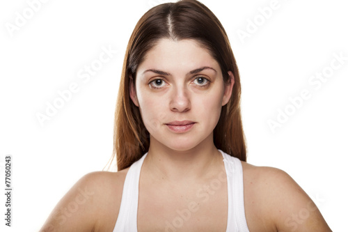 young woman without make-up on white background