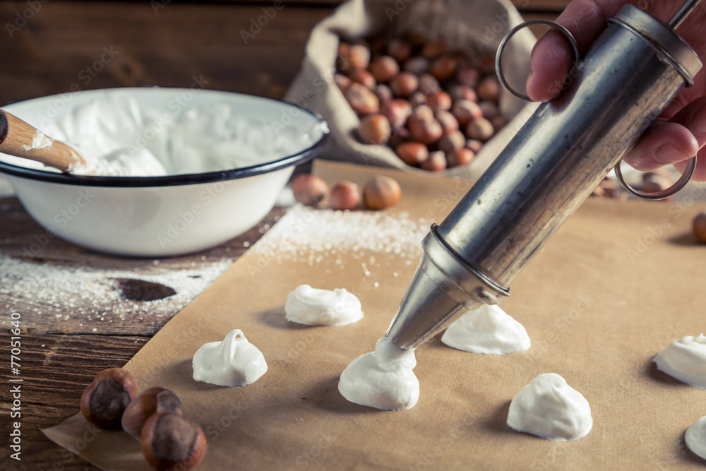 Applying meringues on baking paper for macaroons Applying meringues on baking paper for macaroons