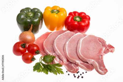 Raw pork meat, vegetables and spices, arranged on kitchen board