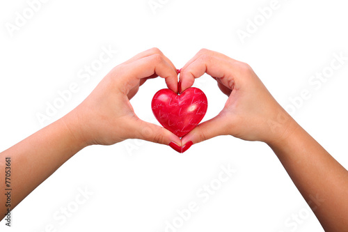 Shape of the heart made by female hands isolated on white