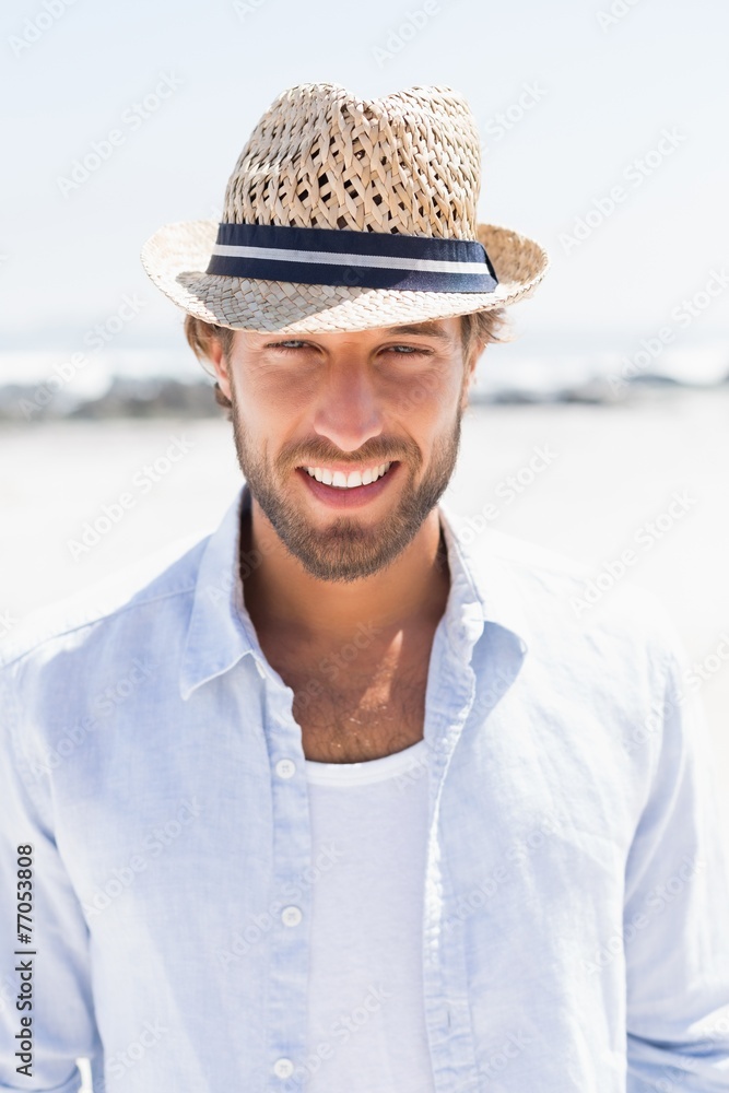Handsome man smiling at camera on promenade