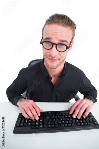 Businessman making a face working at desk