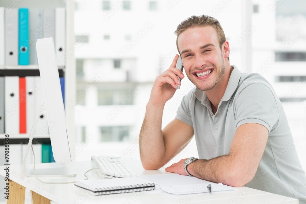Fototapeta premium Smiling businessman making a call