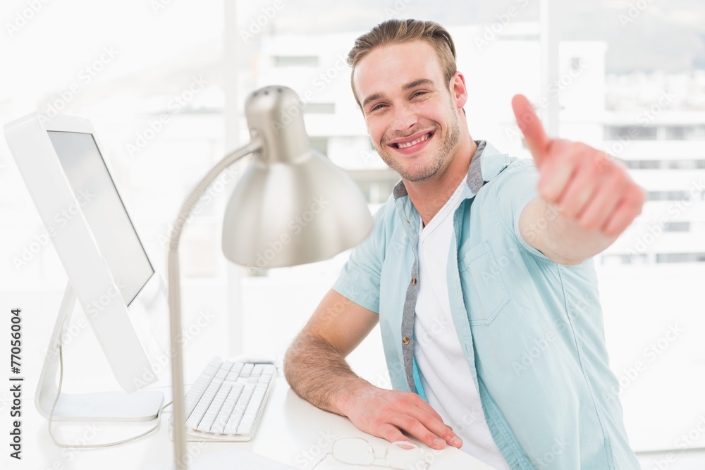 Fototapeta premium Positive businessman smiling with thumb up
