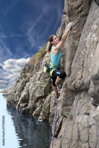 Brave and confident female rock climber