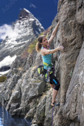 Female alpine climber against mountain landscape