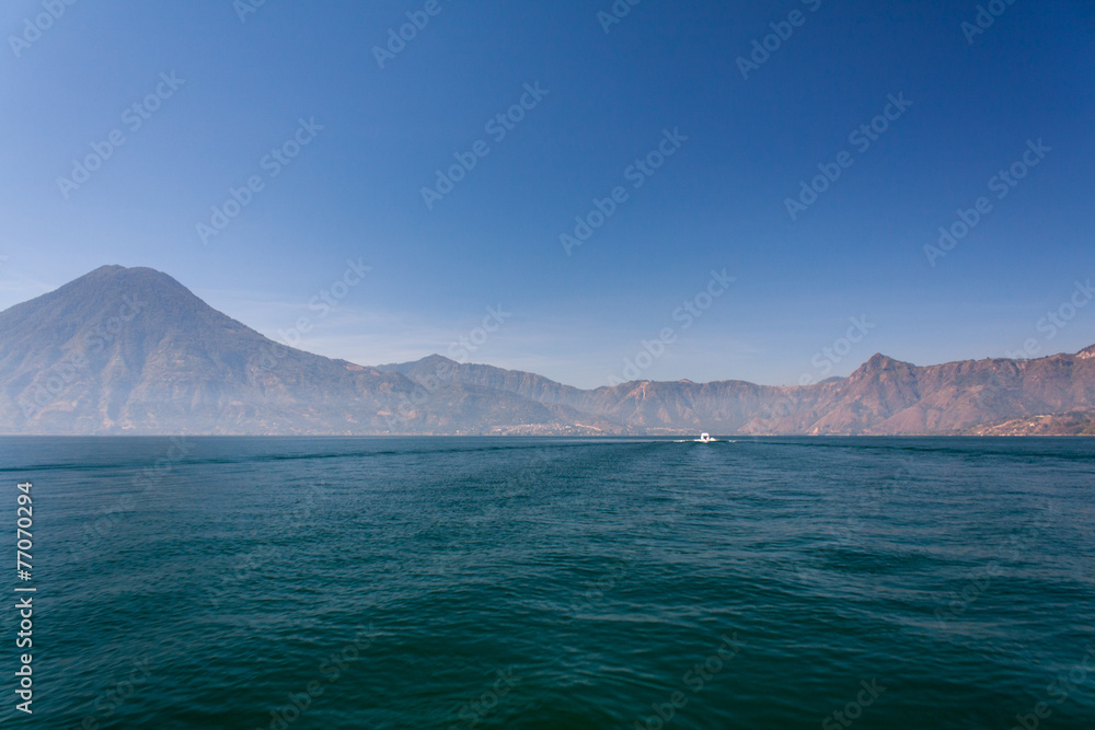Lake Atitlan boat and volcanoes