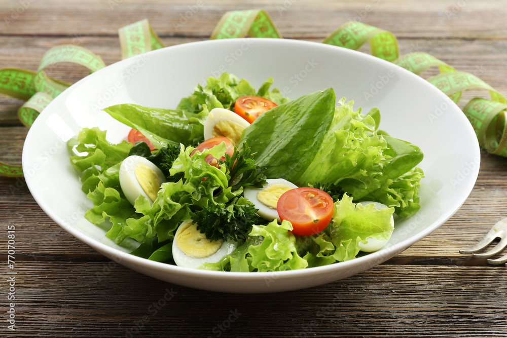 Salad with quail egg and basil in plate Salad with quail egg and basil in plate