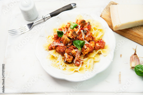 Farfalle pasta with chicken, tomato sauce and mushrooms