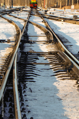 rails in the sun in the snow with turnouts in the foreground