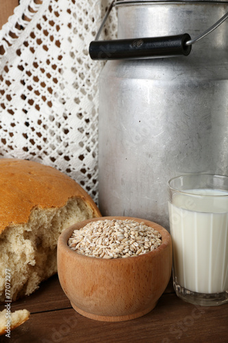 Retro can for milk with fresh bread and glass of milk