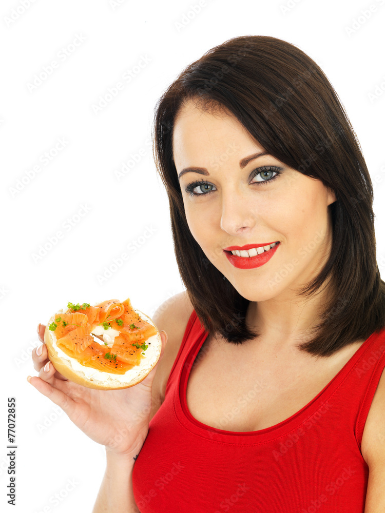 Young Woman Eating Smoked Salmon and Cream Cheese Bagel