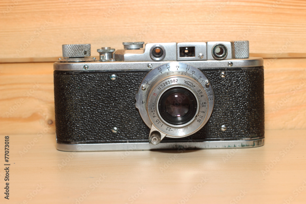 Vintage camera on a wooden background.