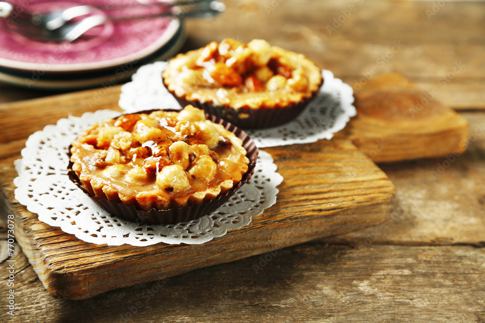 Mini cakes with nuts on wooden background Mini cakes with nuts on wooden background