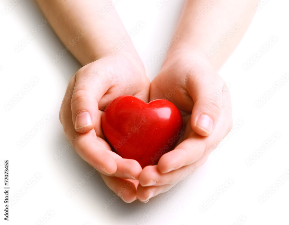 Obraz premium Heart in child hands isolated on white