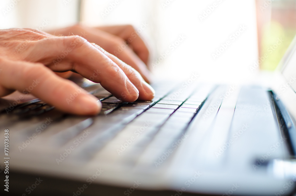 Hand typing on a laptop Hand typing on a laptop