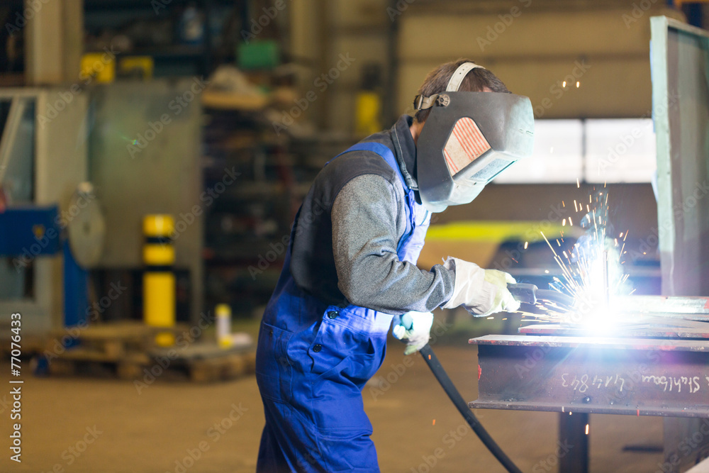Steel construction worker welds metal parts Steel construction worker welds metal parts