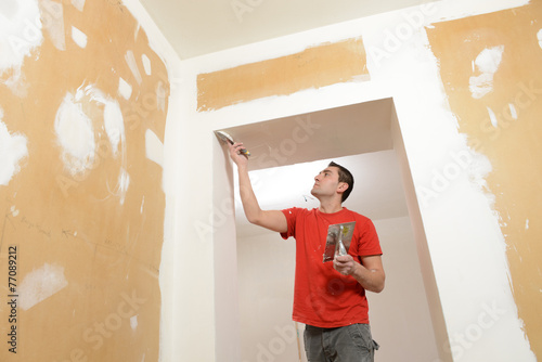 Renovation-Construction: Man installing plasterboard