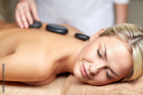close up of woman having hot stone massage in spa