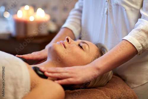 close up of woman having hot stone massage in spa