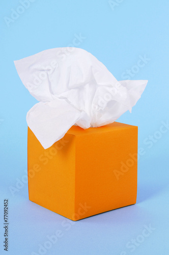 Orange tissue box kleenex style tissues isolated blue background photo photo