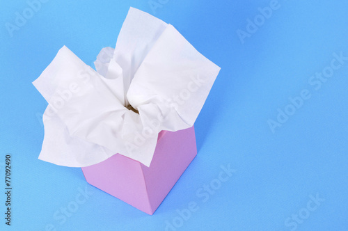 Pink tissue box with kleenex style tissues isolated blue background photo © david_franklin