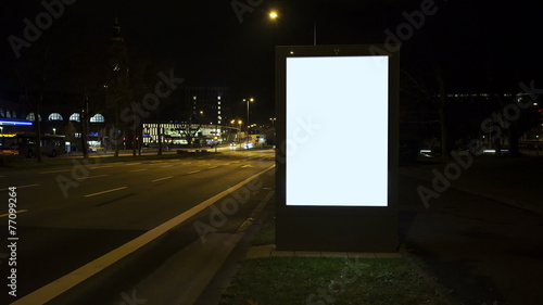 Illuminated blank billboard - Time lapse at night. Copy space