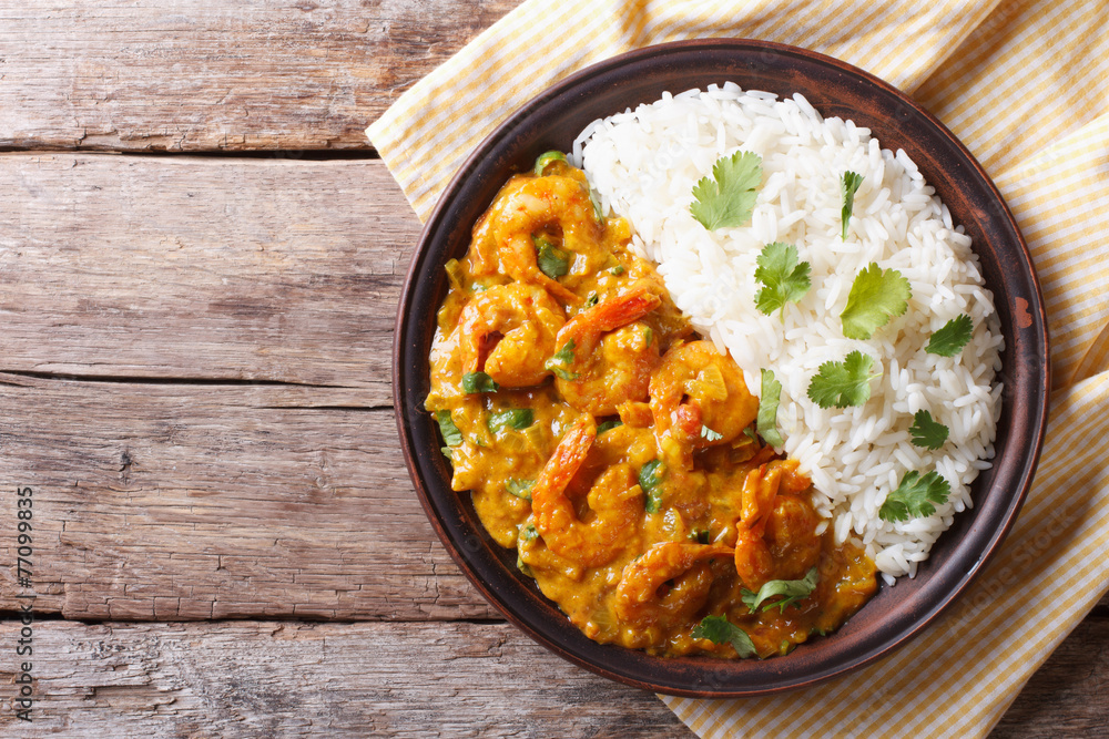 Shrimps curry with rice on a plate. horizontal view from above - obrazy, fototapety, plakaty 