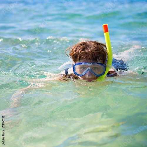 Woman snorkeling in turquoise tropical waters