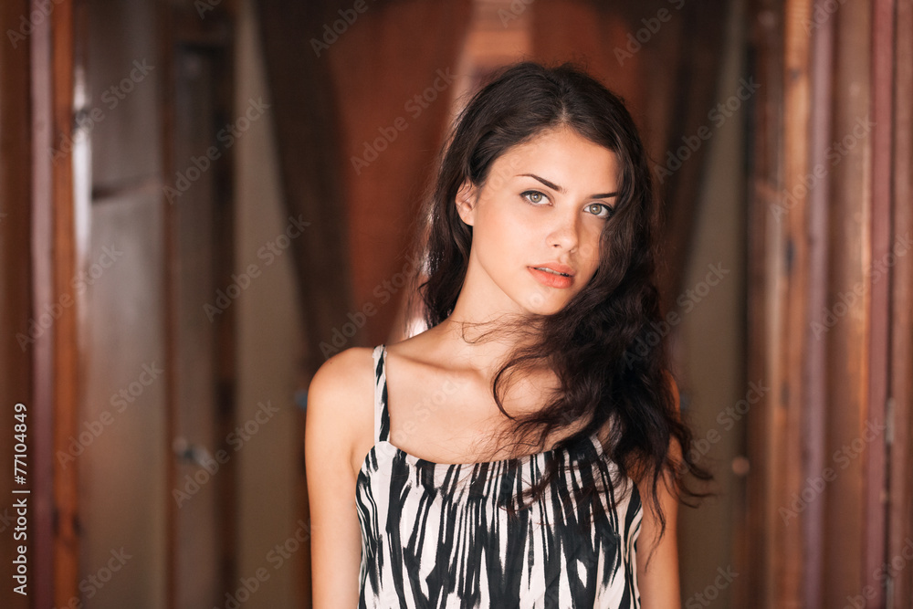 Fototapeta premium Young beautiful brunette woman in summer dress indoor closeup 