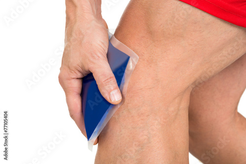 Hand Holding Ice Gel Pack On Knee