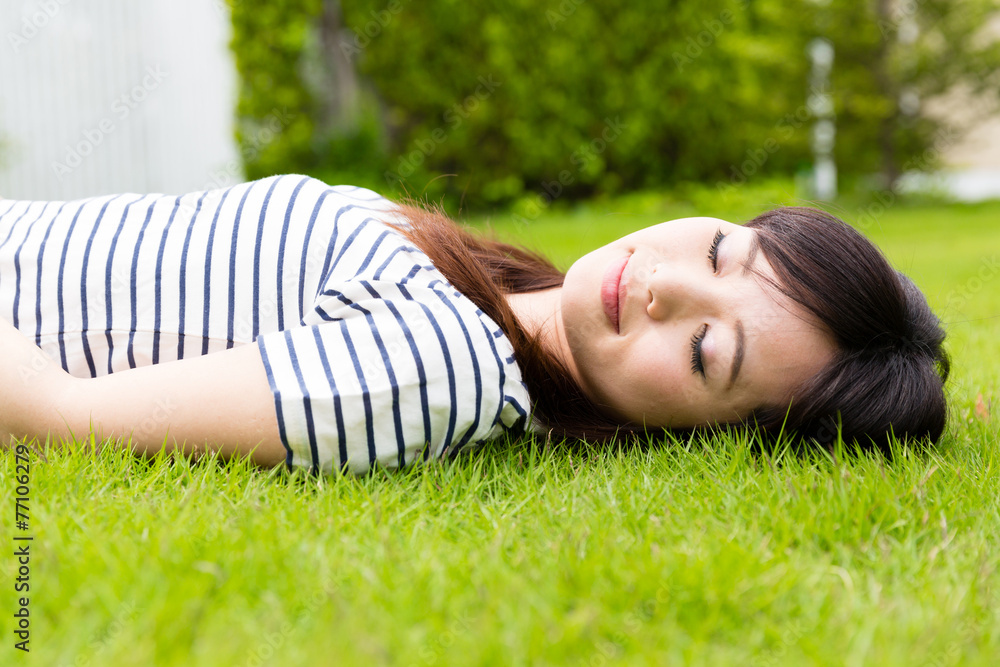 young asian woman lying on the lawn young asian woman lying on the lawn