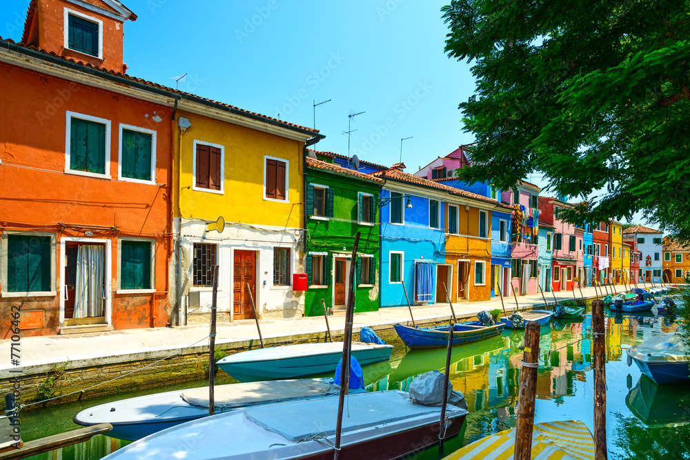 Venice landmark, Burano island canal, colorful houses and boats,