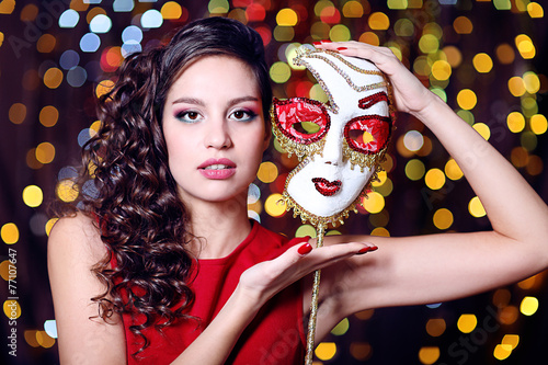 Beautiful girl with masquer...