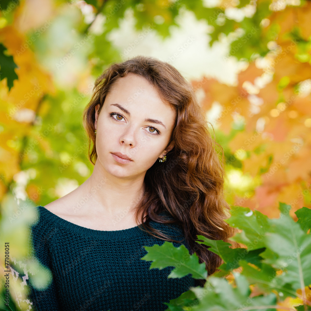 Outdoors portrait of serious beautiful lady in autumn leaves Outdoors portrait of serious beautiful lady in autumn leaves