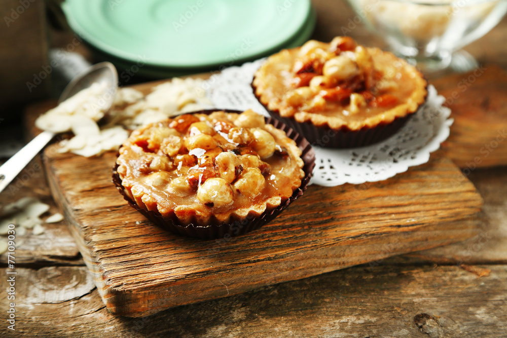Mini cakes with nuts on wooden background Mini cakes with nuts on wooden background