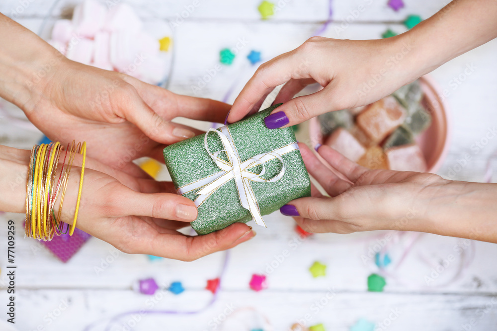 Female hands holding gift close-up Female hands holding gift close-up