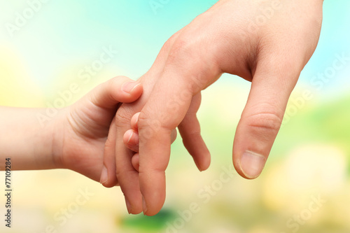 Child and father hands on bright background © Africa Studio