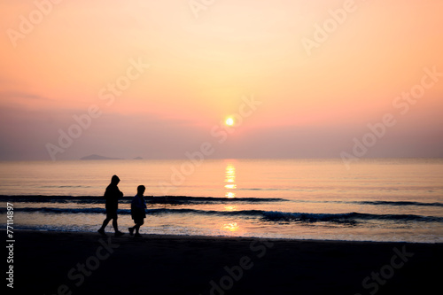 silhouette of couple running on the beach