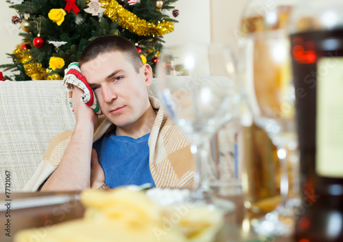 Man in scarf  stuping  towel to head after New Year photo