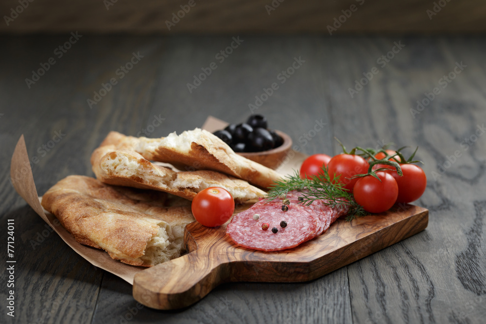 Antipasti with salami, olives, tomatoes and bread Antipasti with salami, olives, tomatoes and bread