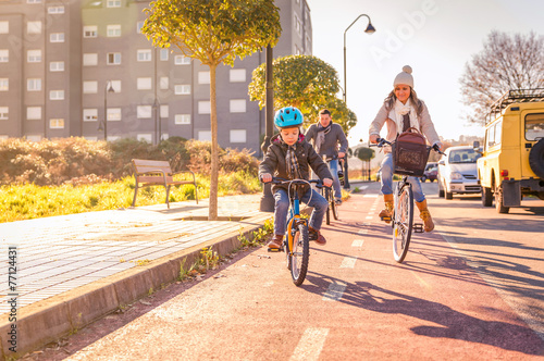 Family with child riding bicycles in the city