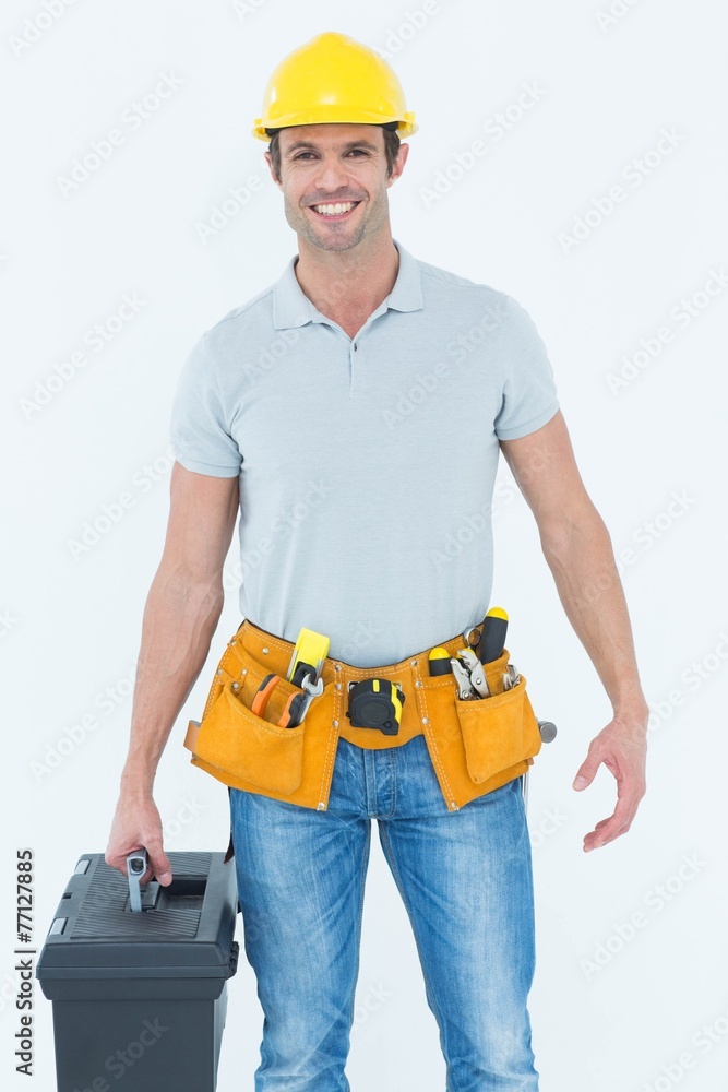 Confident technician holding tool box Confident technician holding tool box