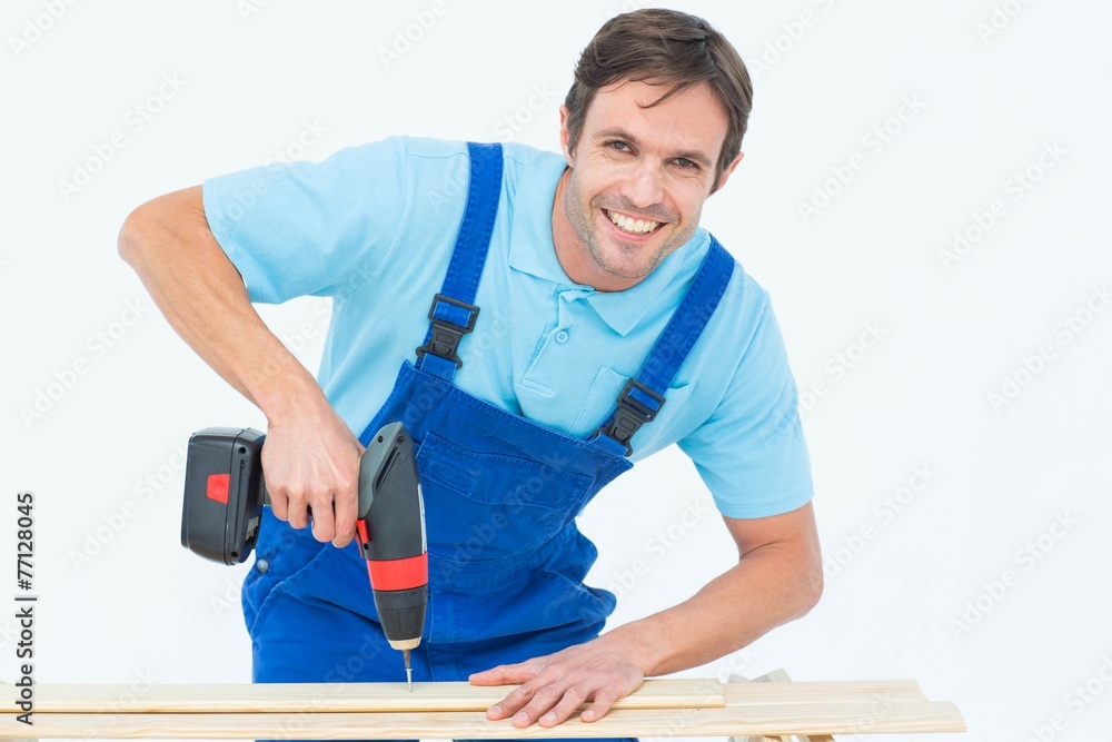 Carpenter using drill machine on wood Carpenter using drill machine on wood