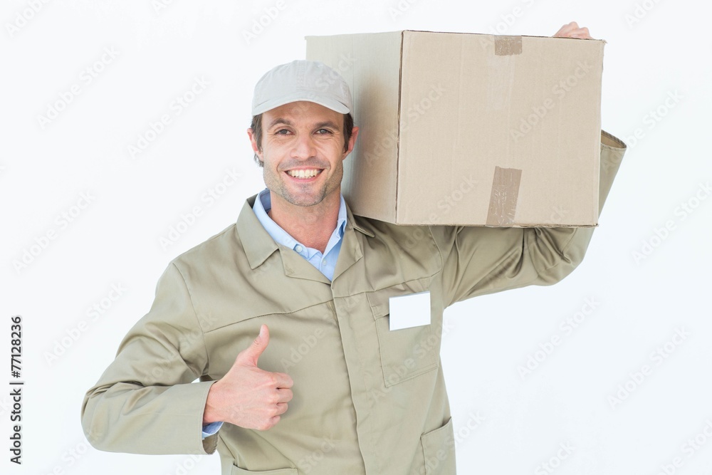 Delivery man showing thumbs up while carrying cardboard box Delivery man showing thumbs up while carrying cardboard box