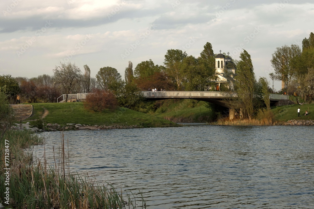 Small dam and christian church in the  residential district