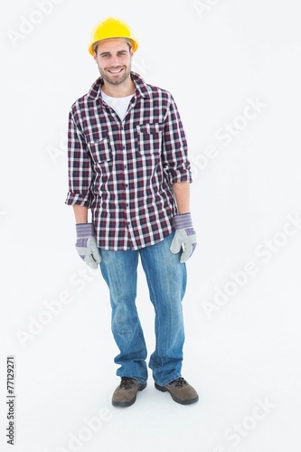 Happy male repairman wearing hard hat